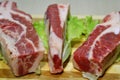 Slices of beef on a wooden board on the table.