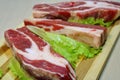 Slices of beef on a wooden board on the table.