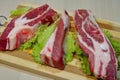 Slices of beef on a wooden board on the table.