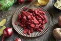 Slices of beetroot on a black plate - preparation of fermented beet kvass