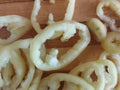 Slices of bell pepper on the wooden background in macro. Chopped bell pepper on a cutting board.