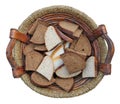 Slices of black and white bread in a homemade wooden basket Isolated