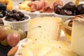 Slices and blocks of cheese, prosciutto, olives, grapes, honey a Royalty Free Stock Photo