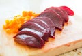 Slices of boiled red beat and carrots on a wooden board Royalty Free Stock Photo