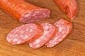 Slices of boiled-smoked sausage on a wooden cutting board Royalty Free Stock Photo