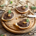 Slices of bread with chocolate cream nuts and knife. Royalty Free Stock Photo