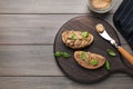 Slices of bread with delicious pate and basil on wooden table, flat lay. Space for text Royalty Free Stock Photo