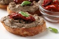 Slices of bread with delicious pate, sun dried tomatoes and basil on napkin, closeup Royalty Free Stock Photo