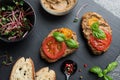 Slices of bread with delicious pate, tomatoes and basil on grey table, flat lay Royalty Free Stock Photo