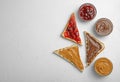 Slices of bread with different spreads on  table, flat lay. Space for text Royalty Free Stock Photo