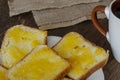 Slices of bread with linden honey on a dark wooden background