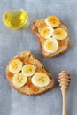 Slices of bread with peanut butter, bananas and honey Royalty Free Stock Photo