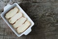 Slices of bread soaking in milk to make torrijas. Copy space Royalty Free Stock Photo