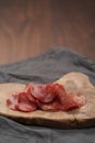 Slices of bresaola on olive serving board