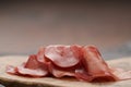 Slices of bresaola on olive serving board