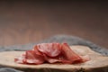 Slices of bresaola on olive serving board