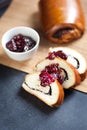 Slices of butter poppy roll, served with cherry jam. Royalty Free Stock Photo