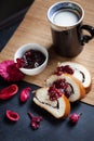 Slices of butter poppy roll, served with cherry jam and large ceramic cup with hot drink. Royalty Free Stock Photo