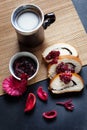 Slices of butter poppy roll, served with cherry jam and large ceramic cup with hot drink. Royalty Free Stock Photo