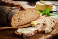 Slices of buttered rye bread with loaf Royalty Free Stock Photo