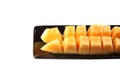 Slices cantaloupe melon fruit in blackdish. Royalty Free Stock Photo