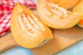 Slices of cantaloupe melon on rustic table Royalty Free Stock Photo