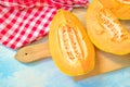 Slices of cantaloupe melon on rustic table Royalty Free Stock Photo