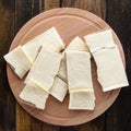 Slices of cheese on bread toasts wooden background