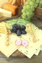 Slices of cheese with grapes and radisches