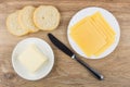 Slices of cheese in plate, bread, piece of butter