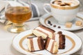 Slices of chocolate cake, brandy and coffee with cream