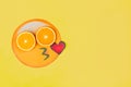 Funny emoji with slices citruses eyes