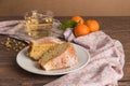 Slices of clementine cake with powdered sugar topping and cup of