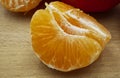 Slices of clementine mandarin on wooden table. Macro image