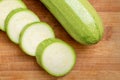 Slices of courgettes on wooden board Royalty Free Stock Photo