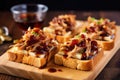 slices of crispy bread topped with carolina pulled pork and vinegar sauce