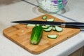 Slices of cucumber and knife on the cutting board. Royalty Free Stock Photo