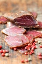 Slices of cured meet on wooden table Royalty Free Stock Photo