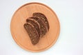 Slices of dark rye and whole wheat bread with sesame seeds on wooden board background. Royalty Free Stock Photo