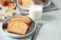 Slices of delicious gingerbread cake served with milk on light grey table Royalty Free Stock Photo