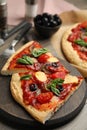 Slices of delicious pita pizza on wooden board, closeup