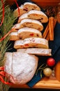 Slices of Dresden Stollen with dried cranberies and nuts. Festive European dessert. Christmas baking concept. Top view. Royalty Free Stock Photo