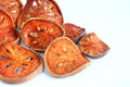 Slices of dried bael fruit on white Royalty Free Stock Photo