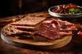 Slices of dried beef on a wooden board.