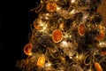 Slices of dried oranges decorate the Christmas tree, close-up Royalty Free Stock Photo