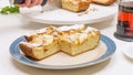 Slices of fresh baked Apple pie close up on a plate on white kitchen table. Royalty Free Stock Photo