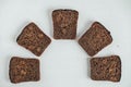 Slices of fresh brown bread with raisins on a white wooden background. Top view. Copy, empty space for text Royalty Free Stock Photo