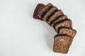 Slices of fresh brown bread with raisins on a white wooden background. Top view. Copy, empty space for text Royalty Free Stock Photo