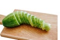 Slices of fresh green cucumber on a cutting board. isolated white background Royalty Free Stock Photo