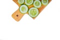 Slices of fresh green cucumber on a cutting board. isolated white background. copyspace Royalty Free Stock Photo